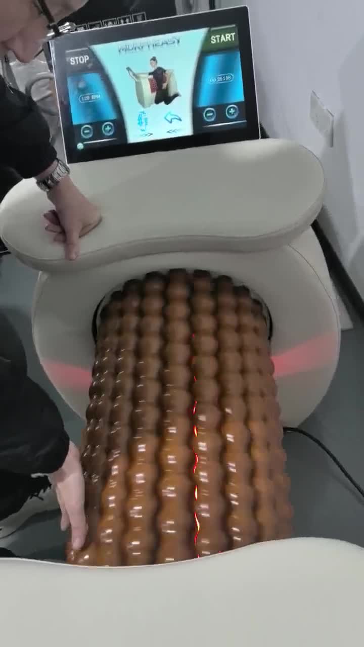 Frame from supplied development footage showing the roller mechanism, padded support and control display